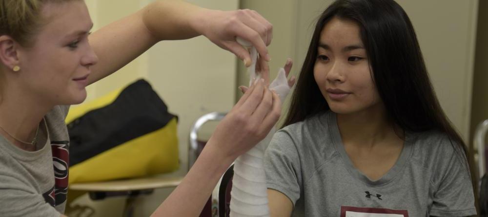 Athletic training students working together in class